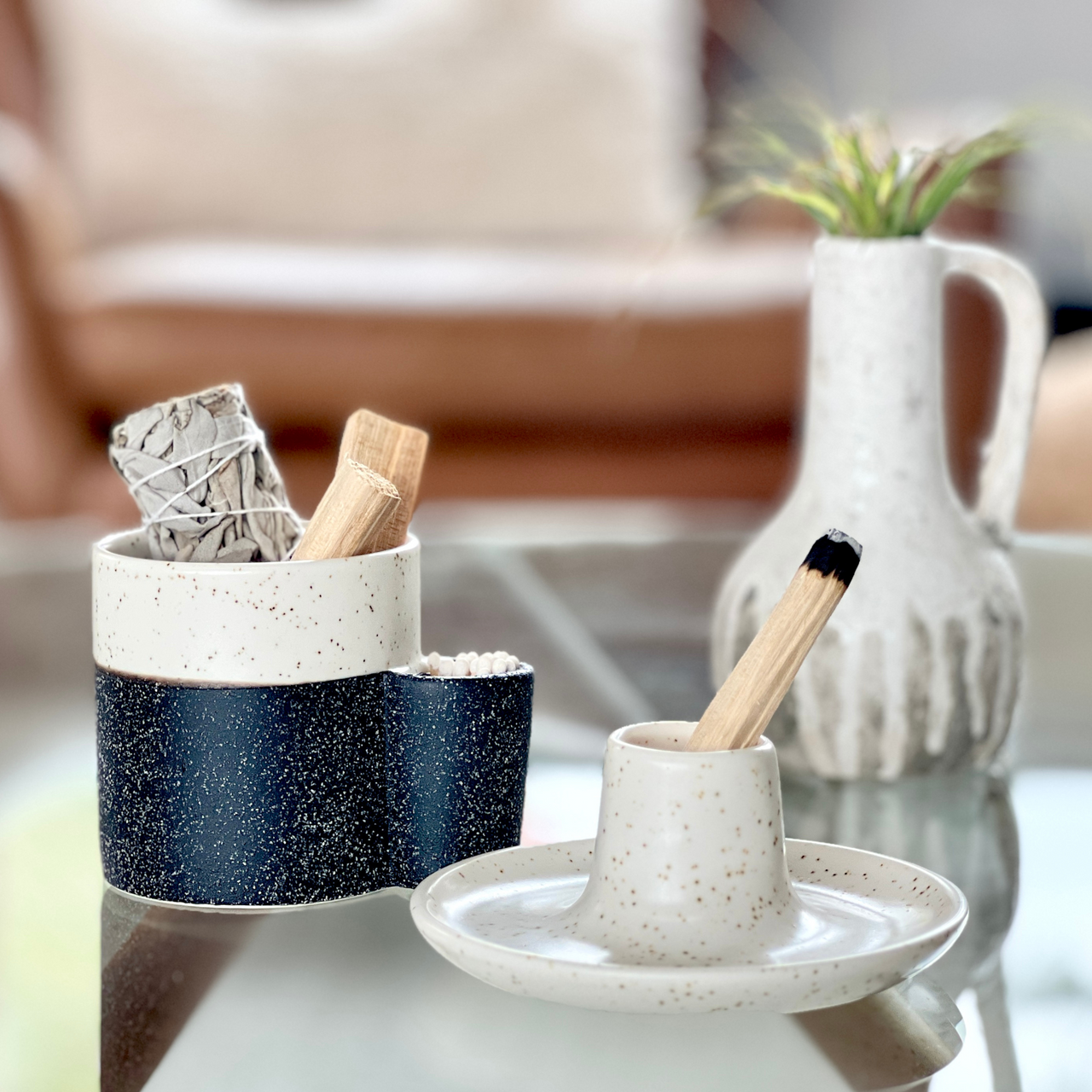 photo of a white ceramic palo santo holder on a table